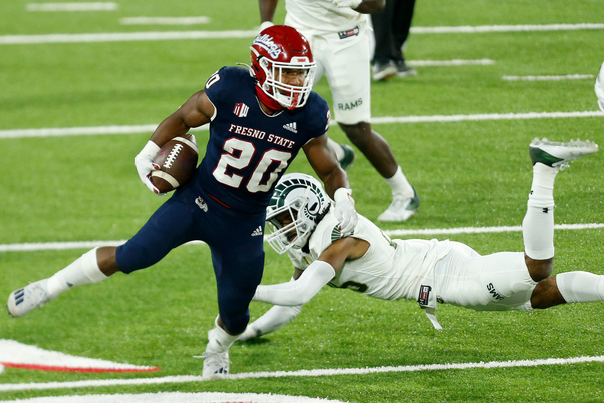 Fresno State running back Ronnie Rivers (20) breaks through the grips of Colorado State defensive back Keevan Bailey (25) in the Bulldogs' 38-17 win over Colorado State on Oct. 29, 2020.